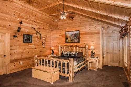 a bedroom with a bed in a log cabin at Cloud Dancer in Gatlinburg