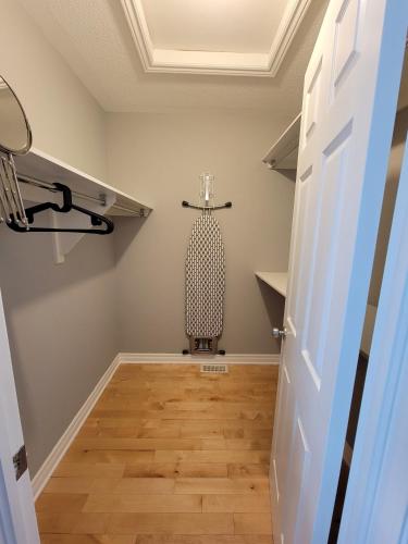 a hallway with a table and a chair in a room at Cozy 3 bedroom town house 20 min from Ottawa down town and airport in Ottawa