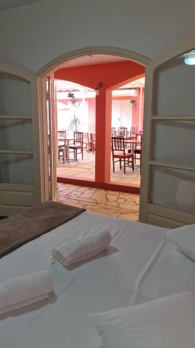 a room with a bed and a table and chairs at Pousada Casa Doce Vida in Águas de Lindóia