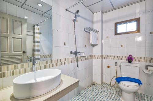 a bathroom with a sink and a toilet at Lucky Buako Hotel Patong in Patong Beach
