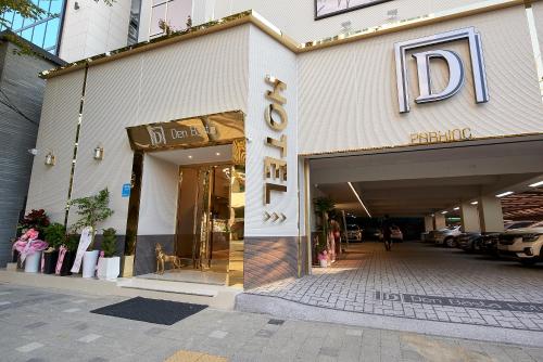 a store front of a building with a sign on it at Denbasta Hotel in Busan