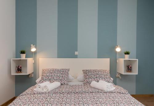 a bedroom with a bed with pillows on it at House POLUS in Trogir