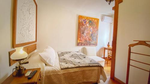 a bedroom with a bed and a table with a lamp at Studio 522 in Santiago