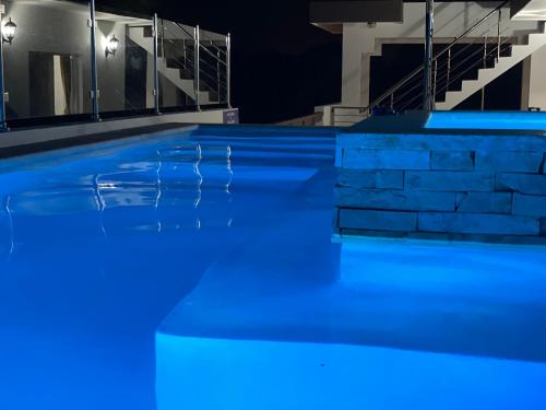 an empty swimming pool at night with blue illumination at Apartamento Carey in Cabrera