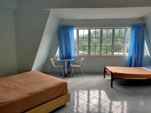 Postel nebo postele na pokoji v ubytování Ria Cameron Hotel