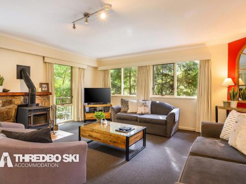 a living room with a couch and a table at Sequoia 4 in Thredbo