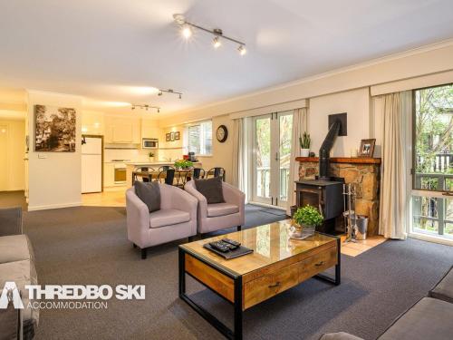 a living room with a couch and a table at Sequoia 4 in Thredbo