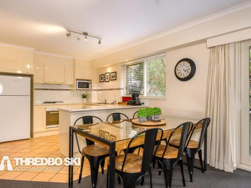 a kitchen and dining room with a table and chairs at Sequoia 4 in Thredbo