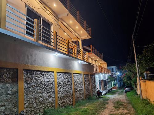 a building with balconies on the side of it at night at APARTHOTEL VISTA LAGO in Flores