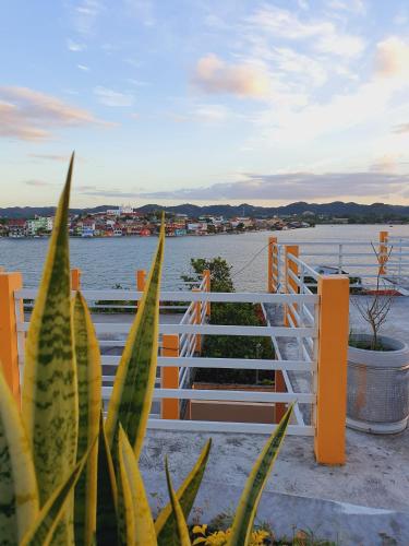 a fence with a view of the water at APARTHOTEL VISTA LAGO in Flores