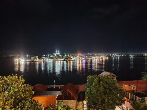a view of a city at night with the water at APARTHOTEL VISTA LAGO in Flores