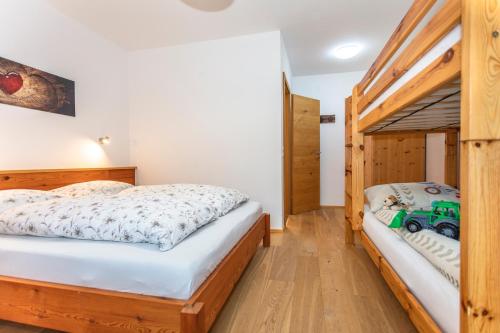 a bedroom with two beds and a truck bed at Ferienwohnungen Weberbauer in Sankt Martin bei Lofer