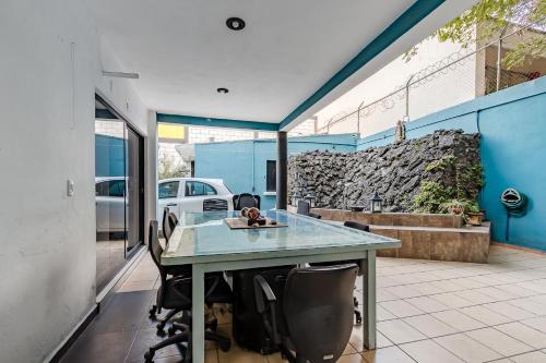 an office with a glass table and chairs at RCH Suite in Mexico City