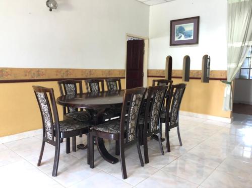 a dining room with a table and chairs at AbgZul Homestay in Kota Bharu