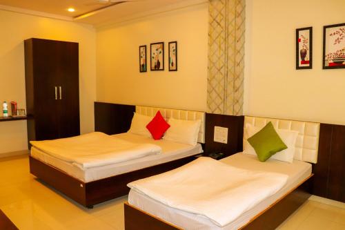 Ein Bett oder Betten in einem Zimmer der Unterkunft Hotel Neem Tree