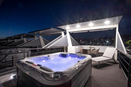 a jacuzzi tub on a balcony at night at The Sea Lodges Portoroz - Hausboot Floating Sea House in Portorož