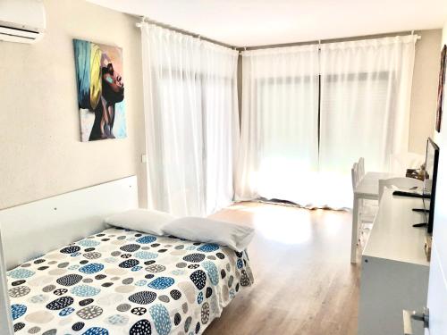 a bedroom with a bed in front of a window at Diplomatic Salou in Salou