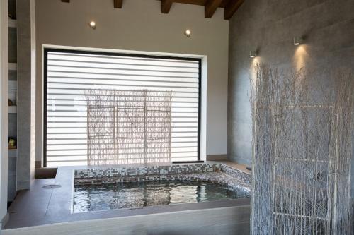 a bathroom with a large window and a bath tub at Relais I Castagnoni in Rosignano Monferrato