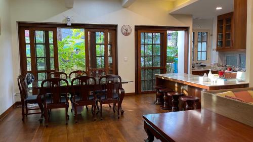 a kitchen and dining room with a table and chairs at Chan Home Villa in Bangkok