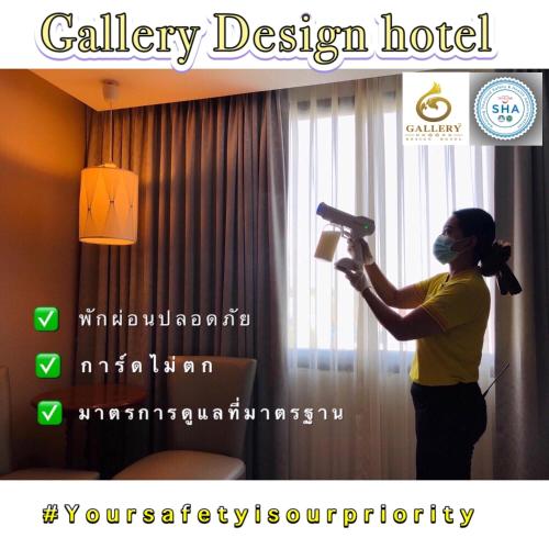 a woman standing in a hotel room holding a hair dryer at Gallery Design - SHA Extra Plus in Si Sa Ket
