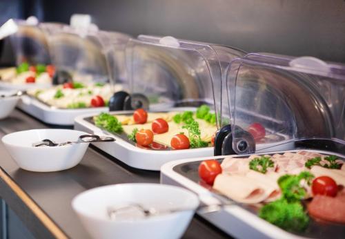 a buffet line with several trays of food at Ocak Hotel in Berlin