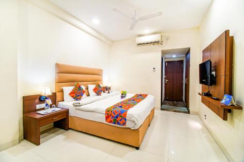 a bedroom with a bed and a television in it at FabHotel Prime President- Bhopal Railway Station in Bhopal