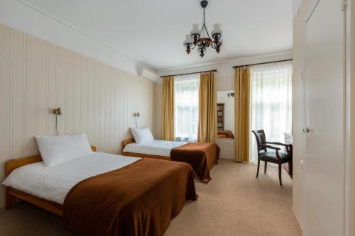 a hotel room with two beds and a desk at Verevi Motel in Elva