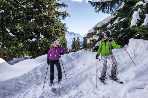2 personnes debout à skis dans la neige dans l'établissement Belambra Clubs Les Saisies - Les Embrunes - Ski pass included, à Villard-sur-Doron