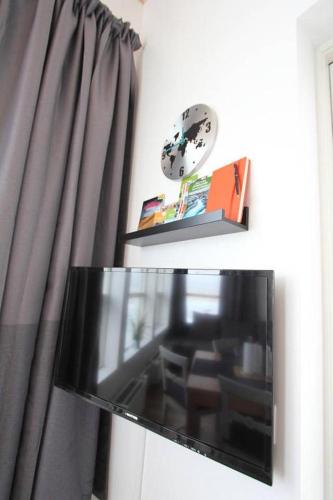 a flat screen tv sitting in front of a window at Blue View Cabin 4A With private hot tub in Reykholt