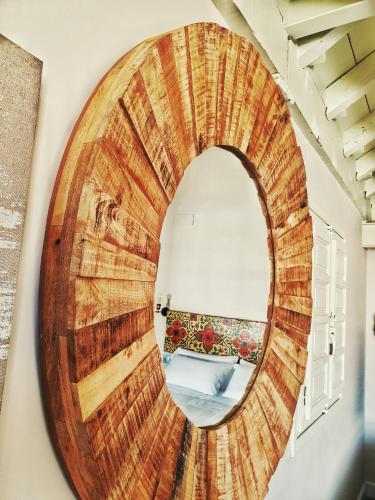a circular mirror on a wall in a room at 4U Suites in Granada
