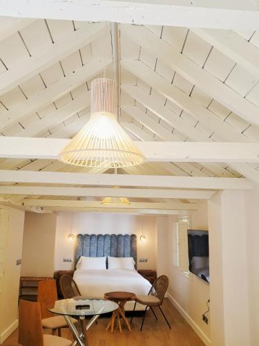 a bedroom with a bed and a table and chairs at 4U Suites in Granada