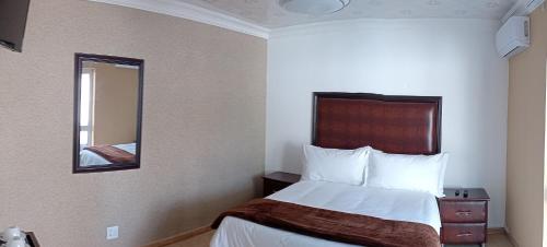 Ένα ή περισσότερα κρεβάτια σε δωμάτιο στο Le Rubis Guesthouse
