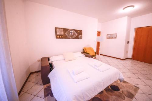 a bedroom with a large white bed in a room at 1Dest - Best Location in Riva del Garda