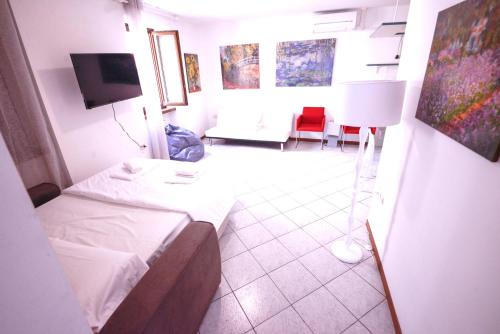 a hotel room with two beds and a tv at 1Dest - Best Location in Riva del Garda