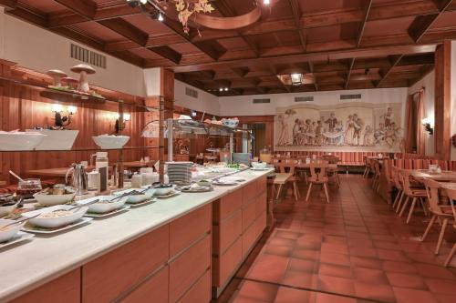 a restaurant with a long counter with dishes on it at Hotel Weinbauer in Schwangau