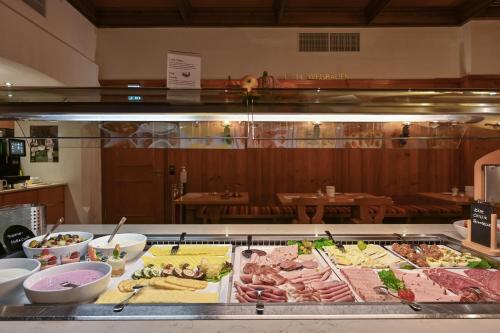 a buffet with many different types of food on a counter at Hotel Weinbauer in Schwangau