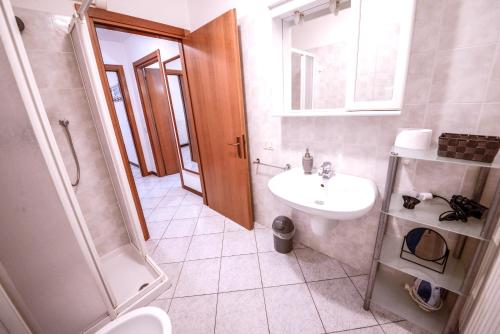 a bathroom with a sink and a toilet and a shower at 1Dest - Best Location in Riva del Garda