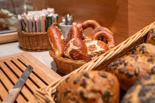 a basket of bread and pretzels on a table at Hotel Weinbauer in Schwangau