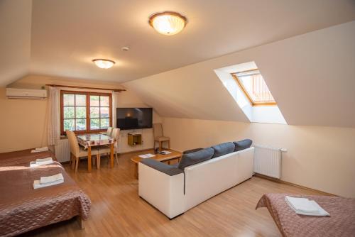 a living room with a couch and a table at Apartmán a ubytování U Machů in Mikulov