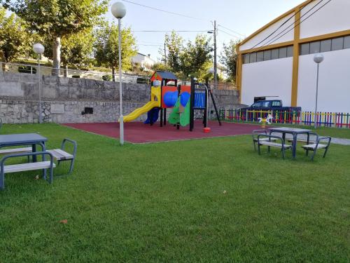 a park with benches and a playground at Casa do Adro - Serra da Estrela in Cortes do Meio