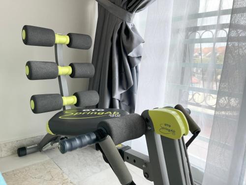 a room with a bench with weights at Century Suria Aparment Langkawi by Zervin in Kuah