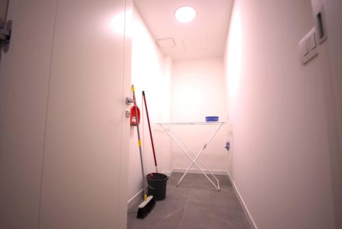 a room with a glass door and a broom at 1Dest - Best Location in Riva del Garda