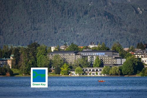 a sign in the water in front of a large building at Hotel Park - Sava Hotels & Resorts in Bled