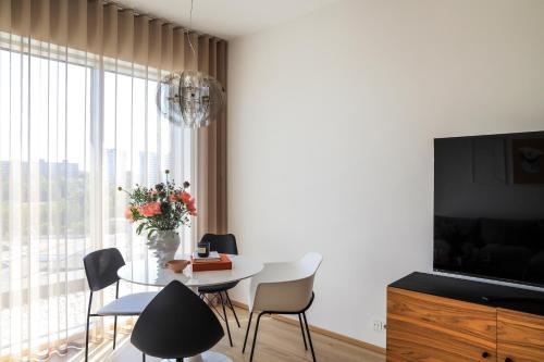 a living room with a table and a large window at Kadriorg Plaza 2 bedroom FREE Parking in Tallinn