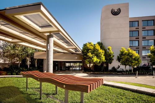 a bench in the grass in front of a building at Riverside Sun in Vanderbijlpark