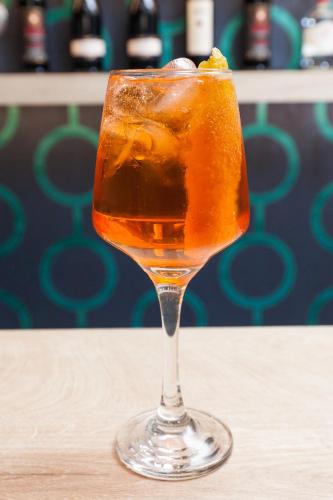 a drink in a glass sitting on a table at Trendy Hotel by Athens Prime Hotels in Athens