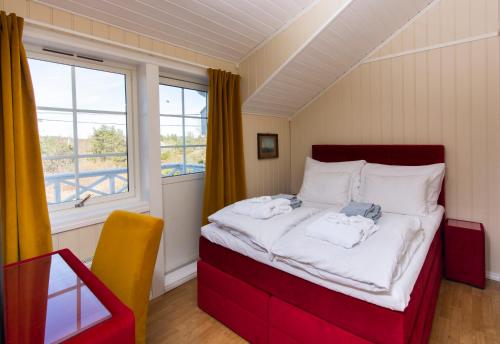 a bedroom with a large bed with a window at Arendal Herregaard Spa & Resort in Arendal
