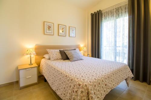 a bedroom with a bed and a large window at Casa Falset in L'Estartit