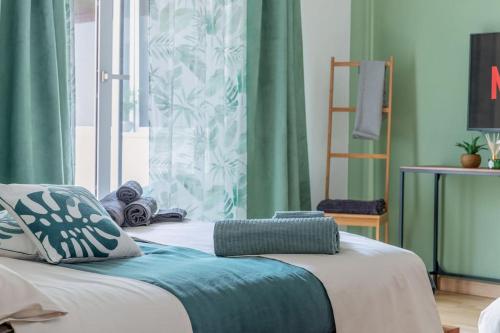 two beds in a room with green curtains and a window at G&G Green Garden - Appartamento con Ampio Terrazzo esterno By followgreenhouserome in Rome