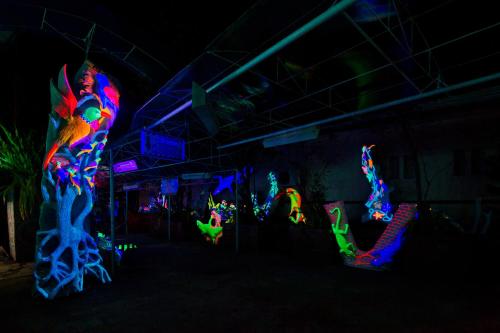 a group of people in a room with neon lights at Deep Forest Garden Hotel in Puerto Princesa City